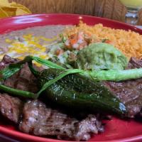 Carne Asada · Slices of skirt steak cooked over charcoal. Served with guacamole, broiled green onions, jal...