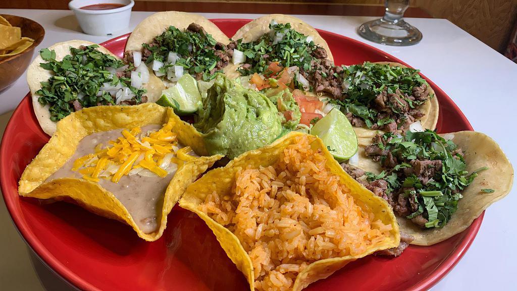 Street Tacos · Five soft corn tortillas served with sliced steak. Served with onions, cilantro and special sauce. Served with rice and beans.