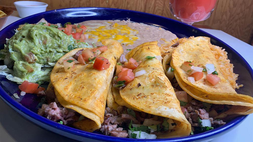 Tacos Al Carbon · Choice of tender beef skirt steak or marinated chicken breast, flame-broiled, sliced and folded into three soft corn tortillas with pico de gallo. Topped with guacamole.