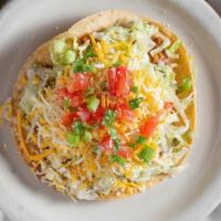 Tostada · Corn tortilla fried flat topped with beans, your choice of protein, lettuce, tomato, cheese,...