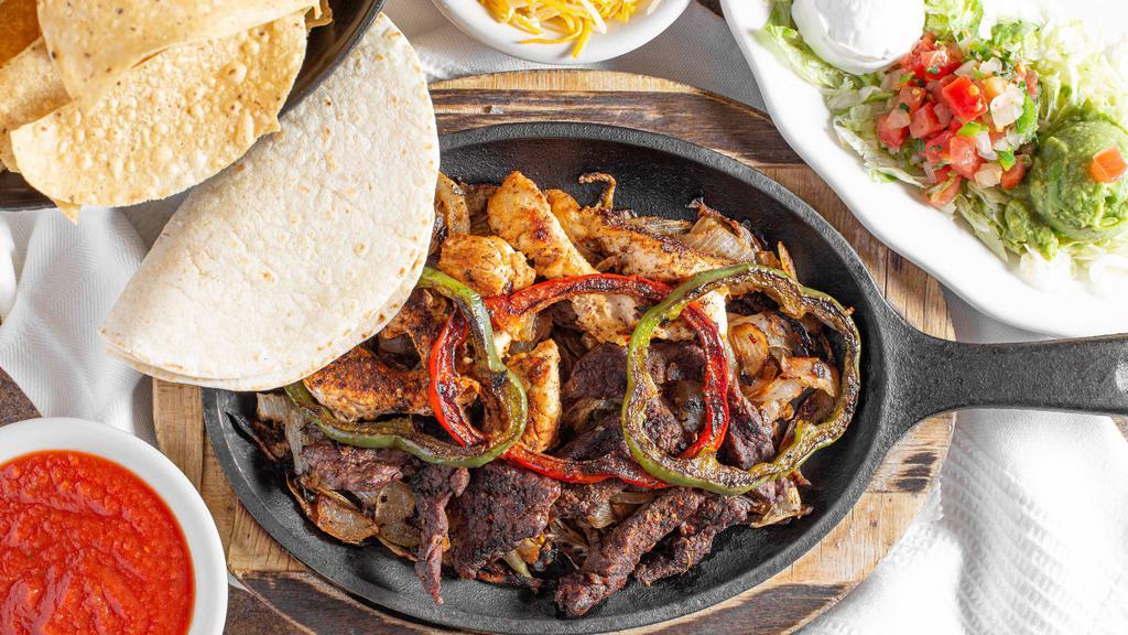 Fajitas · Our special blend of seasonings cooked over steak, chicken, pork, shrimp or veggies. Served sizzling over grilled onions and red and green peppers. Enjoy fresh guacamole, tangy pico de gallo, cheese and cool sour cream. Your choice of tortillas.
