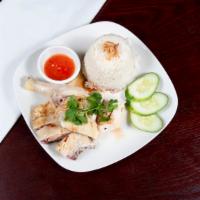 Hainanese Chicken Rice · Steamed chicken in bone with sweet soy sauce and special chili sauce served with chicken fla...