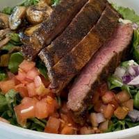 Blackened Steak · Grilled Certified Angus Beef, bleu cheese crumbles, romaine, sautéed mushrooms, tomato and r...