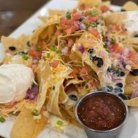 Nachos Grande · Tortilla chips, cheese blend, pepper jack queso, black beans, tomato, red onion, green onion...