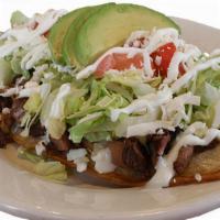 Huarache · Thick oval corn masa topped with beans, lettuce, tomatoes, avocado slices, queso fresco, and...