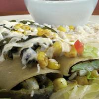 Enchiladas Dona Irene · 2 corn and poblano pepper enchiladas, covered with Mx cream, and queso fresco. Served with w...