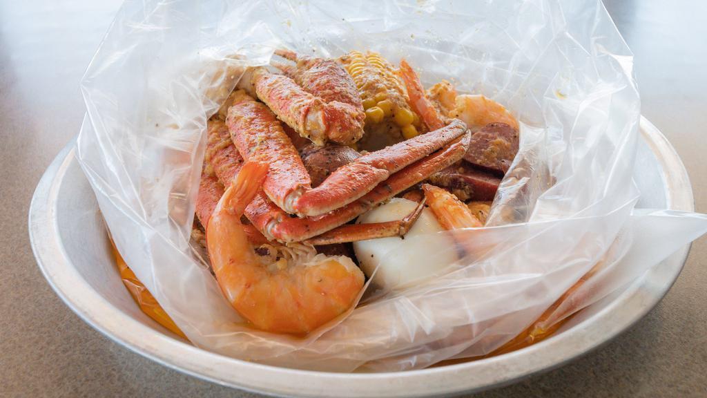 Famous Low Country Boil · Half pound snow crab legs, half pound shrimp (no head), half pound all-meat sausage, one boiled egg, one corn, one potato.