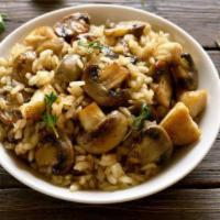 Mushroom Risotto · Creamy cremini mushroom risotto topped with fried leeks and chives