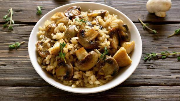 Mushroom Risotto · Creamy cremini mushroom risotto topped with fried leeks and chives