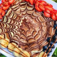 Zeina Fruit Crepe · Milk, dark and white chocolate with strawberries and bananas.