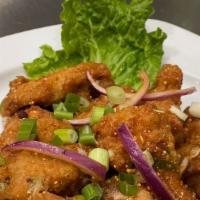 Wing Zab · Fried chicken wings with spicy and sour sauce, onion, and rice powder