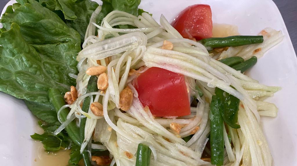 Sl5 Papaya Salad · Gluten free. Shredded green papaya, tomatoes, green bean, and peanut in lime dressing served with lettuce leaves.