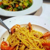 Scampi · Wild caught shrimp in a lemon, garlic and white wine sauce served over linguine.