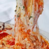 Lasagna · Baked layers of ground veal, ricotta, mozzarella, and pasta, topped with tomato sauce.