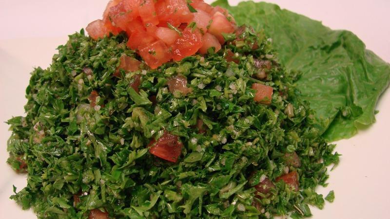 Tabouleh · Chopped tomatoes, onions, mint, parsley, bulgur, and tossed with a delightful mixture of olive oil and lemon juice.