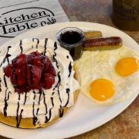 Strawberry Waffle Combo · Crisp belgian waffle topped with strawberries and chocolate sauce. Served with two eggs and ...
