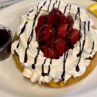 Belgian Waffle With Strawberries · Crisp belgian waffle topped with strawberries and chocolate sauce. (no sides)