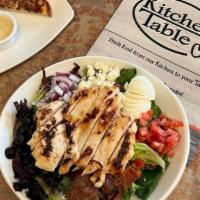 Cobb Salad · Fresh greens, grilled chicken breast, diced bacon, tomato, hard boiled egg, black olives, re...
