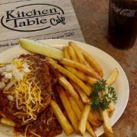 Chili Burger · Open faced burger, smothered in homemade chili. Topped with onions, cheddar and jack cheese.