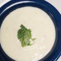 Raita · Homemade creamy yogurt blended with cucumber and herbs.
