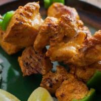 Chicken Tikka · Boneless chicken marinated in spices and baked tandoor (clay oven).