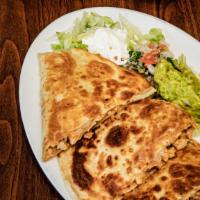 Steak Quesadilla · Flour tortilla stuffed with meat and melted cheese and served with lettuce sour cream pico d...