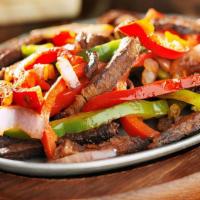 Fajitas De Steak · Grilled Rib eye with peppers green yellow and red and onios  
Served with Spanish rice and r...