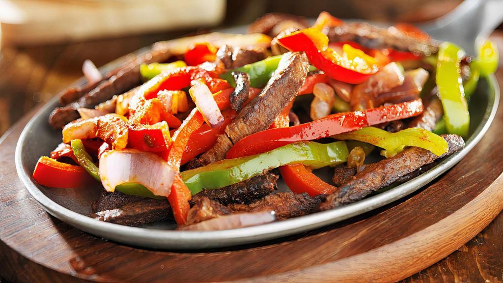 Fajitas De Steak · Grilled Rib eye with peppers green yellow and red and onios  
Served with Spanish rice and refried pinto beans and tortillas