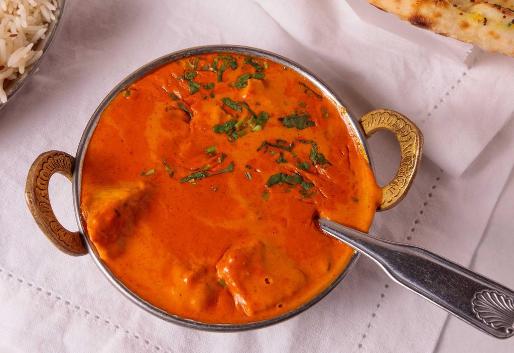 Chicken Tikka Masala · Chicken breast tenders in marinated in spices and yogurt, baked in tandoor oven and cooked in tomato base cream sauce.