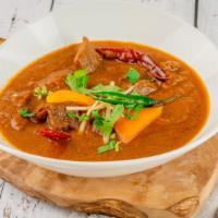 Goat Curry · Juicy chunks of young goat meat on the bone simmered until tender in a piquant gravy