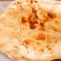 Naan · Unleavened white floor bread baked in tandoor.