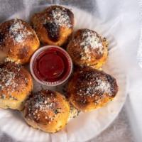 Cheesy Garlic Knots (6 Pieces)
 · Cheese stuffed bread knots tossed in garlic butter, TCP's secret Italian seasoning and Parme...
