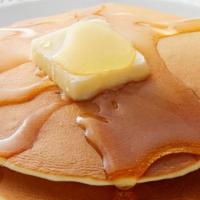 Pancakes · Two buttermilk pancakes served with butter and syrup.