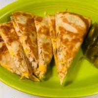 Texas Quesadilla · 12'' tortilla filled with cheese, your choice of fajita chicken or fajita beef.  Includes gu...