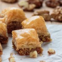 Baklava · Flaky filo dough pastry soaked in a simple syrup topped with crushed nuts.