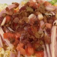 Chef Salad · Ham, turkey, cheese, bacon bits and diced tomatoes.