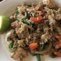 Green Curry Fried Rice · Fried rice with onions, carrots, green beans, bell peppers, and fresh basil in a green curry...