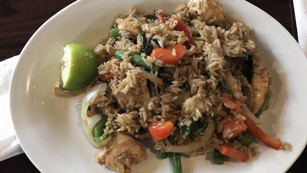 Green Curry Fried Rice · Fried rice with onions, carrots, green beans, bell peppers, and fresh basil in a green curry paste with a choice of meat.