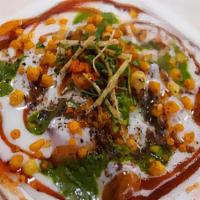 Chaat Papri · Chickpeas, onions, potatoes, mixed with yogurt, and tamarind chutney topped with crispy frie...