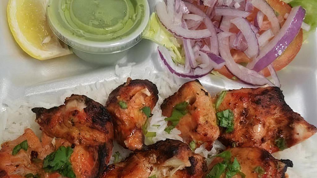 Chicken Tikka Kabob · Boneless chunks of chicken marinated in yogurt, seasoned in mild herbs and spices then charbroiled. Served with basmati rice, naan, and salad.