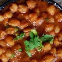 Chana Masala · Chana masala is a North Indian curried dish made with white chickpeas, onions, tomatoes, spi...