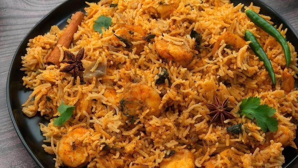 Shrimp Biryani (10-12 Pcs) · Biryani is a delicious dish served in an Indian dish made by cooking basmati rice with meat, yogurt, spices & herbs. Shrimp marinated with herbs, spices, and nuts in basmati rice. Served with raita (yogurt sauce).