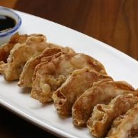 Gyoza · Pan-fried chicken dumplings served with say sauce.