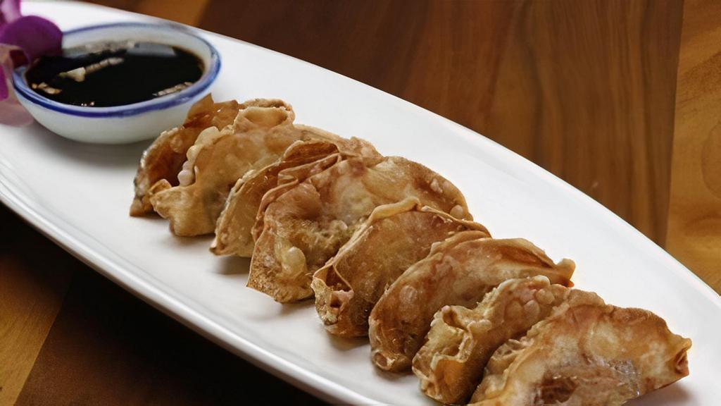 Gyoza · Pan-fried chicken dumplings served with say sauce.