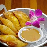 Half Moon · Crispy wontons filled with cream cheese and crab meat served with plum sauce. (6pc).
