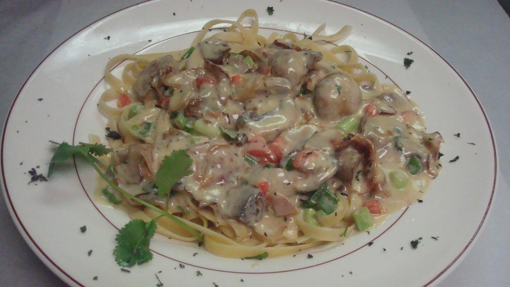 Fettuccine Ala Carbonara · Freshly made fettuccine noodles, lightly tossed in a creamy garlic sauce, with bacon, mushrooms and scallions.