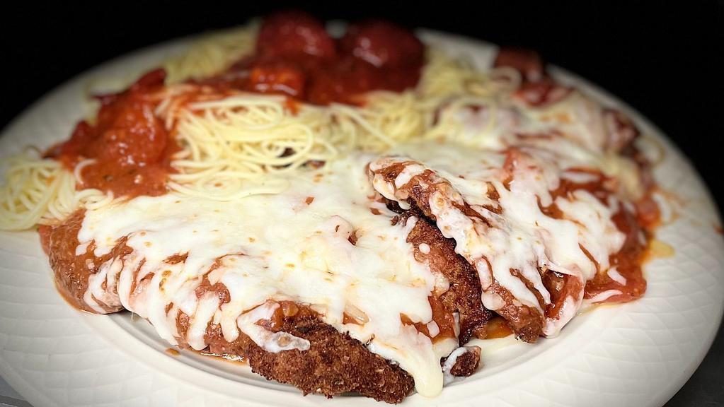 Veal Parmigiana · Tender veal lightly breaded and topped with mozzarella cheese and tomato sauce and baked. Served with freshly made pasta.