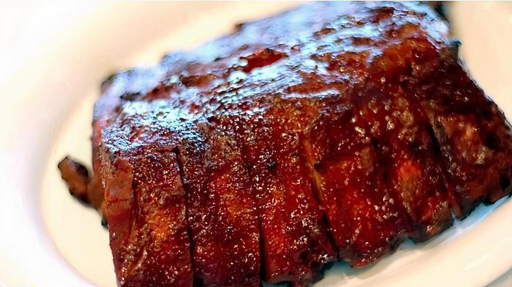 Baby Back Ribs (Half Rack) · Half rack slow cooked baby back ribs infused with mesquite barbecue sauce.