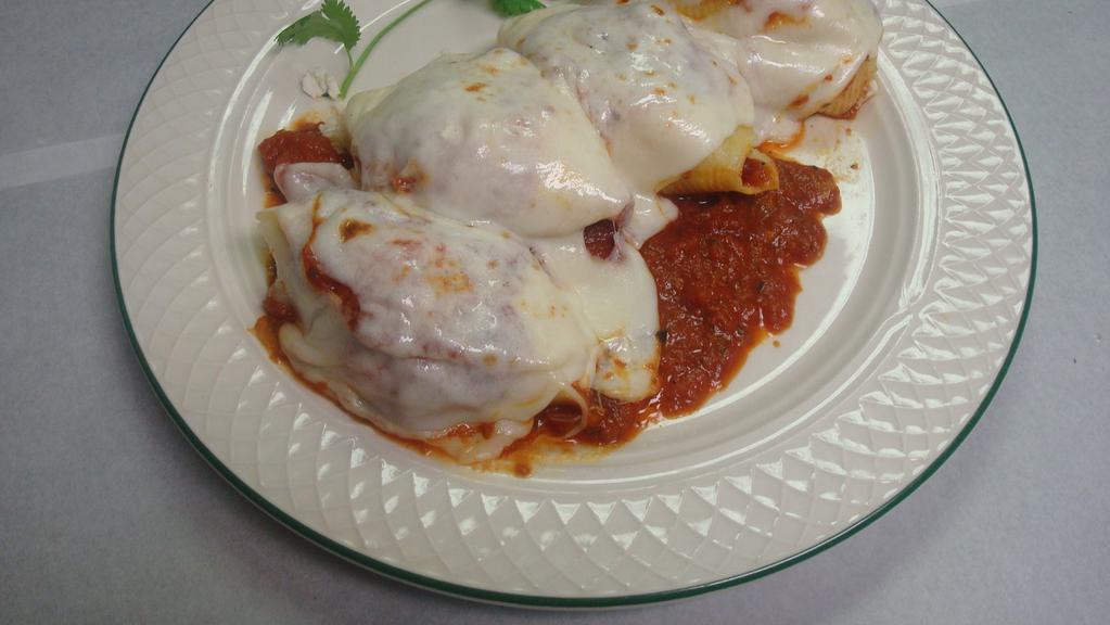 Stuffed Shells · Large pasta shells stuffed with three cheeses, baked in marinara sauce, topped with mozzarella cheese.