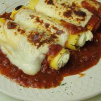 Baked Manicotti · Tender crepe pasta stuffed with a seasoned ricotta cheese and baked in marinara sauce, toppe...